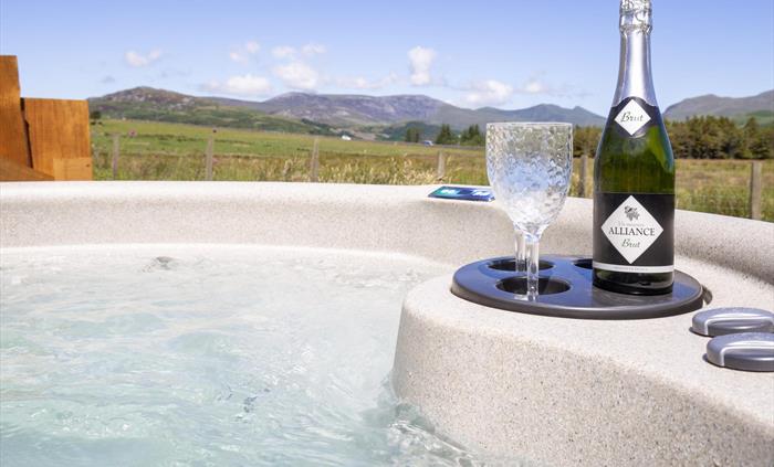 Hot Tub with panoramic views of the Snowdonia Mountains and Cambrian Coast.  Glamping Pod is situated near Criccieth, on a Welsh working farm.